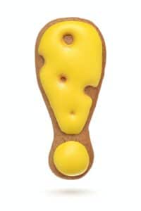 Exclamation mark yellow gingerbread biscuit isolated on white.