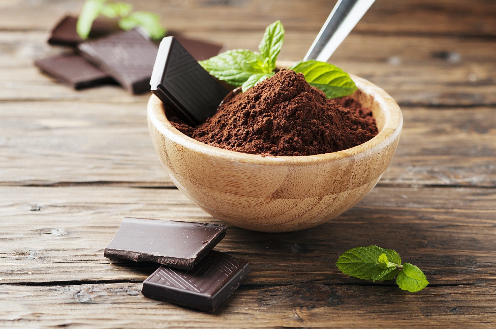 Dark chocolate and cacao on the wooden table